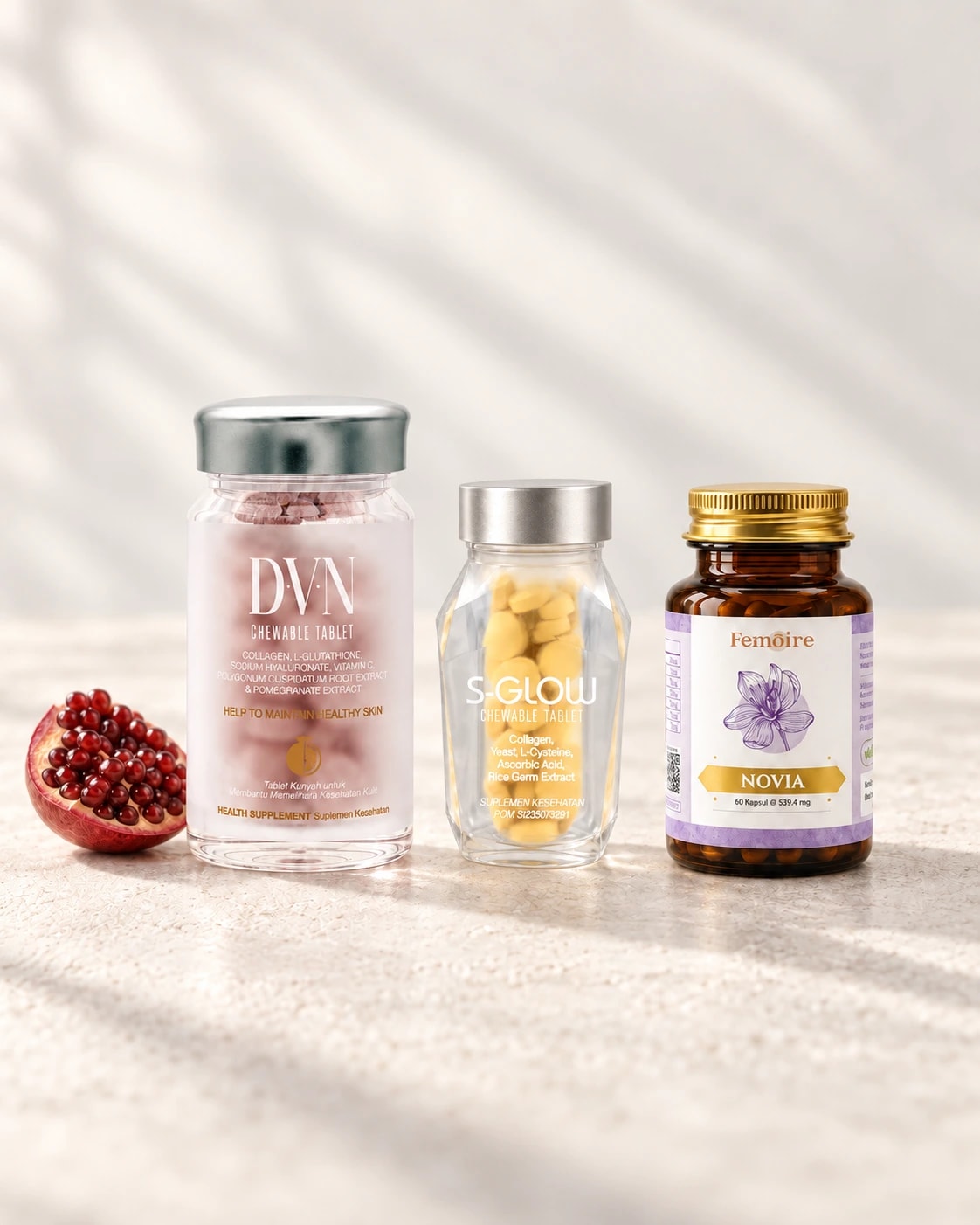DVN, S-GLOW, dan NOVIA ditata bersama delima di atas permukaan ivory dengan cahaya alami.